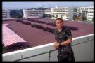 timothy hia yi liang on balcony with parade formation on pop day