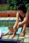 jasper stands in the water, with mei holding from behind