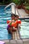 coco and kimber astride the pool divider