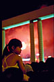 young chinese girl with ponytail against red fireworks smoke