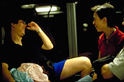wong meng kong & peggy lui share a moment laughing on bus ride back from china national day fireworks, with wong oi yin asleep in wong meng kong's lap