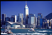 blue daytime hong kong skyline with speedboats seen from star ferry