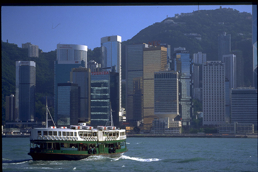 blue daytime hong kong skyline with star ferry seen from star ferry