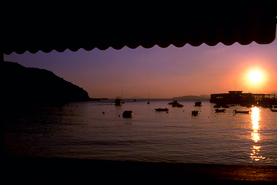 sunset dusk evening with boats over shore with awning